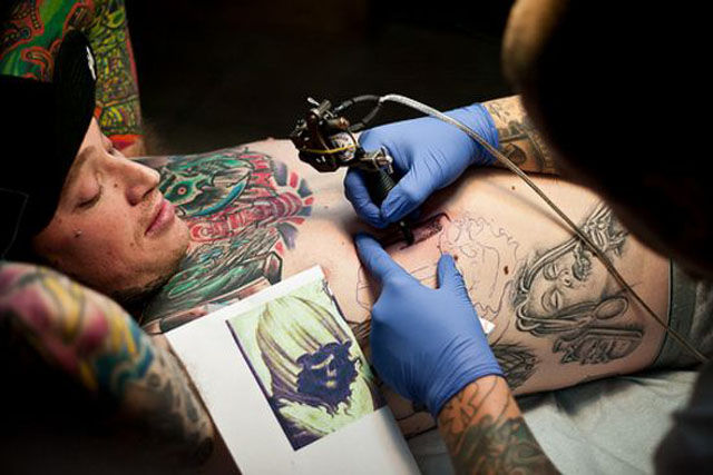 Tattoo Lovers Gather around for Epic Body Art